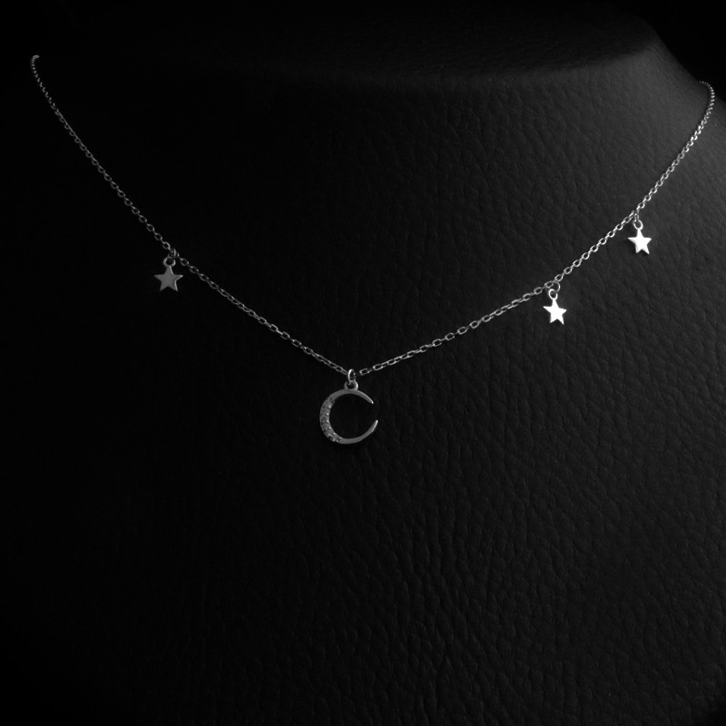 silver necklace with hanging moon and stars