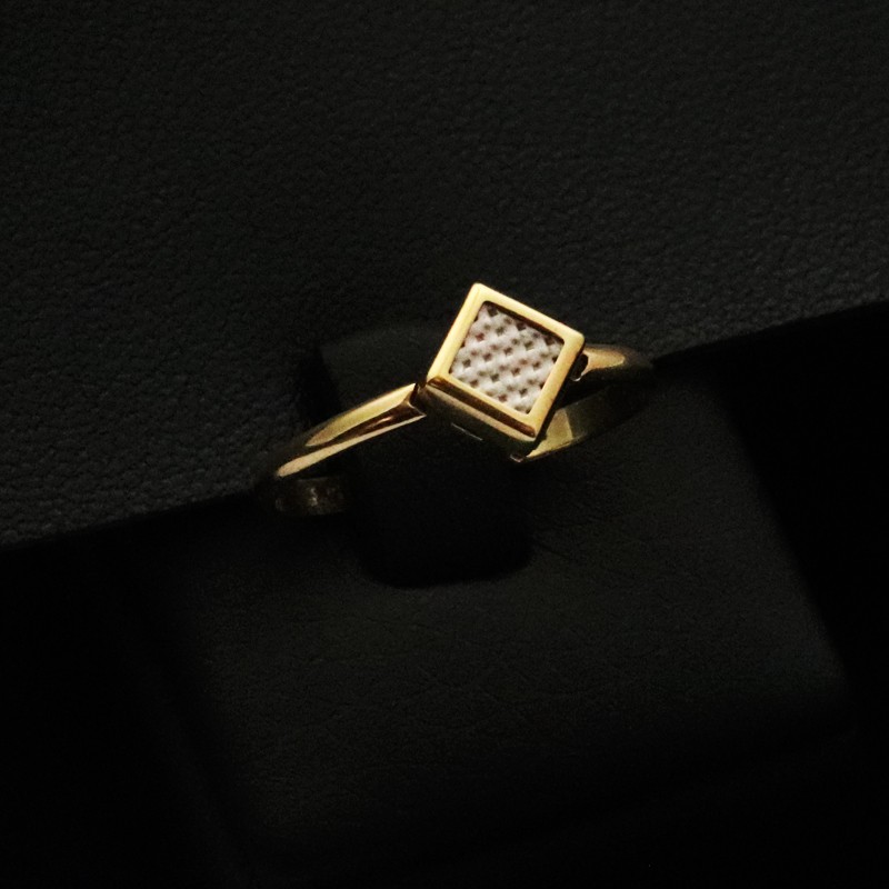 gold ring in the shape of a diamond