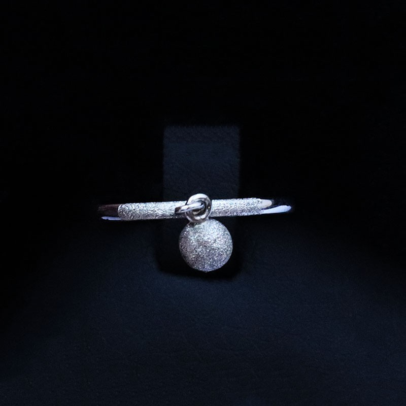 white gold ring with hanging ball
